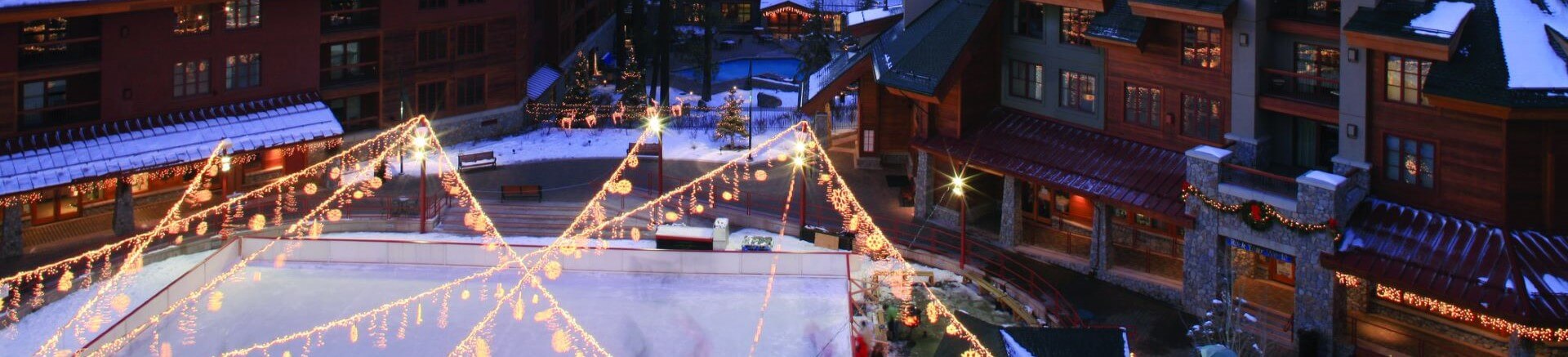The ice rink at Heavenly Village surrounded by festive winter holiday decorations
